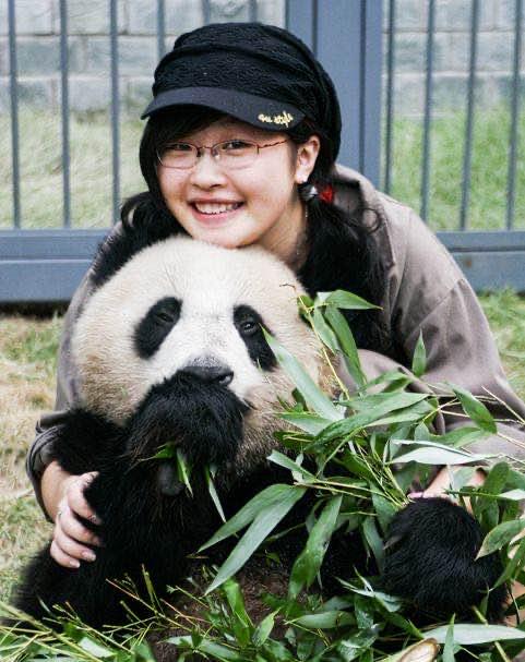 Researcher Binbin Li hugging panda from behind