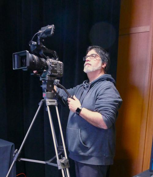 A man behind a Sony video camera